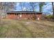 Rear view of a brick house with a large, grassy backyard at 35 Adair Dr, Marietta, GA 30066