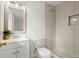 Bathroom featuring shower with decorative tile, modern lighting fixtures, and decorative mirror above the vanity at 35 Adair Dr, Marietta, GA 30066