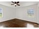 Spacious bedroom featuring hardwood floors, natural light from the windows, and a ceiling fan at 35 Adair Dr, Marietta, GA 30066