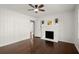 Well-lit bedroom featuring hardwood floors, wainscotting, a fireplace, and crisp, clean white walls at 35 Adair Dr, Marietta, GA 30066