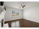 Bright bedroom with a ceiling fan, hardwood floors, and wainscotting surrounding a view of the outdoors at 35 Adair Dr, Marietta, GA 30066