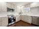 Bright kitchen featuring white countertops, stainless steel appliances, and a view into a sunny breakfast nook at 35 Adair Dr, Marietta, GA 30066