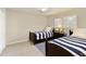 Twin bedroom featuring matching striped bedding, neutral walls, and an abundance of natural light at 168 Maribeau Nw Sq, Atlanta, GA 30327