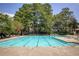 Large community pool surrounded by lounge chairs and lush green trees at 168 Maribeau Nw Sq, Atlanta, GA 30327