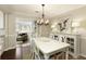 Dining room with a white table and chairs, decorative lighting, and views into the living room at 168 Maribeau Nw Sq, Atlanta, GA 30327