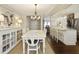 Dining area with white table, chairs, decorative lighting, and views of the kitchen at 168 Maribeau Nw Sq, Atlanta, GA 30327