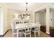 Bright dining room with white table and chairs, elegant lighting, and a decorative buffet at 168 Maribeau Nw Sq, Atlanta, GA 30327