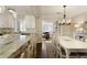 Light-filled dining room with white table and chairs and views of kitchen and the living room at 168 Maribeau Nw Sq, Atlanta, GA 30327