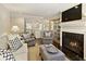 Bright living room features fireplace, flat screen television, and a view into the kitchen at 168 Maribeau Nw Sq, Atlanta, GA 30327