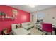 Cozy bedroom with a red accent wall, a sofa, and a desk with a pink chair at 1710 River Mill Ne Trl, Conyers, GA 30012