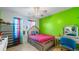 Bright bedroom with a bed, colorful curtains, and an accent wall at 1710 River Mill Ne Trl, Conyers, GA 30012