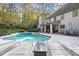 Relaxing backyard features a sparkling pool with lounge chairs and beautifully landscaped surroundings at 2680 Spalding Dr, Sandy Springs, GA 30350