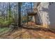 Exterior view of a backyard area with a deck and patio space near a white brick home at 3651 Tulip Dr, Decatur, GA 30032