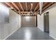 Spacious basement with painted walls, a window, exposed wood beams and gray painted floor at 3651 Tulip Dr, Decatur, GA 30032