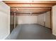 Large basement with gray painted floor and open, unfinished ceiling with ductwork at 3651 Tulip Dr, Decatur, GA 30032