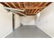 Bright basement with exposed wood beams, gray flooring, a window and access to stairs at 3651 Tulip Dr, Decatur, GA 30032