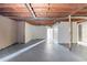 Unfinished basement with gray painted floor and exposed, unfinished ceiling and ductwork at 3651 Tulip Dr, Decatur, GA 30032