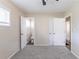 Cozy bedroom with neutral walls, carpet, and access to a bathroom and hall at 3651 Tulip Dr, Decatur, GA 30032