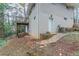 View of the back exterior with a deck and white brick, featuring a back door and gas meter at 3651 Tulip Dr, Decatur, GA 30032