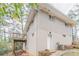 Side exterior of a white brick home with a deck, a back door and a view of the wooded backyard at 3651 Tulip Dr, Decatur, GA 30032