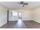 Neutral living room features wood floors, ceiling fan, and opens to other rooms at 3651 Tulip Dr, Decatur, GA 30032