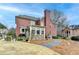 Expansive backyard view of this gorgeous red brick home, including a patio and landscaped yard at 370 Laurel Oak Dr, Suwanee, GA 30024