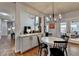 Charming dining area with white table, black chairs, and modern chandelier at 370 Laurel Oak Dr, Suwanee, GA 30024