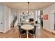 Open dining area with white table, black chairs, and hardwood floors at 370 Laurel Oak Dr, Suwanee, GA 30024