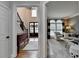 Inviting foyer leading to a living room, showcasing a staircase with iron railing and dark wood floors at 370 Laurel Oak Dr, Suwanee, GA 30024