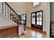 Welcoming foyer with hardwood floors, a staircase, and elegant décor at 370 Laurel Oak Dr, Suwanee, GA 30024