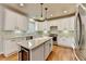 Bright, modern kitchen featuring white cabinets, granite countertops, and stainless steel appliances at 370 Laurel Oak Dr, Suwanee, GA 30024