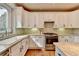 Elegant kitchen featuring white cabinets, stainless steel range, and granite countertops at 370 Laurel Oak Dr, Suwanee, GA 30024