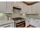 Modern kitchen featuring stainless steel range and white subway tile backsplash at 370 Laurel Oak Dr, Suwanee, GA 30024