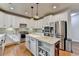 Well-equipped kitchen with an island, stainless steel appliances, and sleek white cabinetry at 370 Laurel Oak Dr, Suwanee, GA 30024