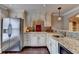 Finished basement kitchenette with stainless steel refrigerator and granite counters at 370 Laurel Oak Dr, Suwanee, GA 30024