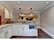 Finished basement kitchenette with granite countertops, stainless microwave and hardwood floors at 370 Laurel Oak Dr, Suwanee, GA 30024