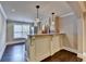 Finished basement kitchenette features granite countertops, bar seating, and hardwood floors at 370 Laurel Oak Dr, Suwanee, GA 30024