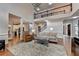 Open-concept living room featuring high ceilings, a stone fireplace, and hardwood floors at 370 Laurel Oak Dr, Suwanee, GA 30024