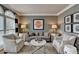 Cozy living room with gray walls, decorative artwork, two armchairs, and a comfortable sofa at 370 Laurel Oak Dr, Suwanee, GA 30024