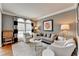 Comfortable living room featuring neutral furniture, a round coffee table, and black and white window treatments at 370 Laurel Oak Dr, Suwanee, GA 30024