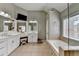 Bathroom with white cabinetry, a soaking tub, a separate shower, and dual sinks at 370 Laurel Oak Dr, Suwanee, GA 30024