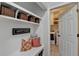 Cozy mudroom with a built-in bench, storage baskets, and 'Happy Place' sign at 370 Laurel Oak Dr, Suwanee, GA 30024