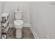 Powder room with a toilet, decor items, tile flooring, and white walls with white trim at 48 Lantern Trce, Hiram, GA 30141