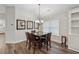 Bright dining room with modern chandelier and a dining table for six near large windows at 48 Lantern Trce, Hiram, GA 30141