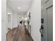 Hallway features neutral walls, wood floors, console table, and an open view to the living area at 48 Lantern Trce, Hiram, GA 30141