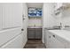 Well-organized laundry room featuring a sink, gray cabinets, and a modern washer and dryer set at 48 Lantern Trce, Hiram, GA 30141