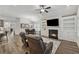 Cozy living room with fireplace, built-ins, a ceiling fan, and seating near the dining area at 48 Lantern Trce, Hiram, GA 30141