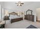 Spacious main bedroom featuring neutral walls, carpet floors, ceiling fan, and elegant furniture at 48 Lantern Trce, Hiram, GA 30141