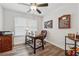 Home office featuring a desk, office chair, dark wood floors, and natural light from the window at 48 Lantern Trce, Hiram, GA 30141