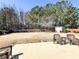 Large backyard with patio, seating, and mature trees for privacy at 5710 Stephens Mill Dr, Sugar Hill, GA 30518